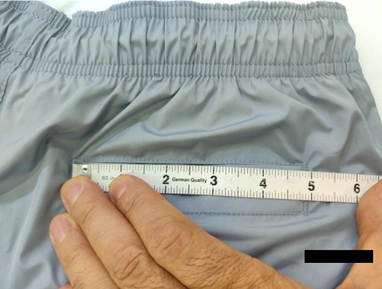 Food quality inspection measuring the diameter of an orange using a digital caliper to verify size and caliber